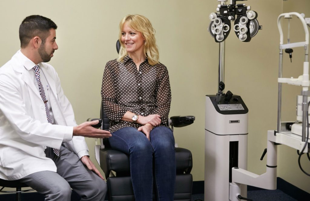 Eye doctor and patient consultation