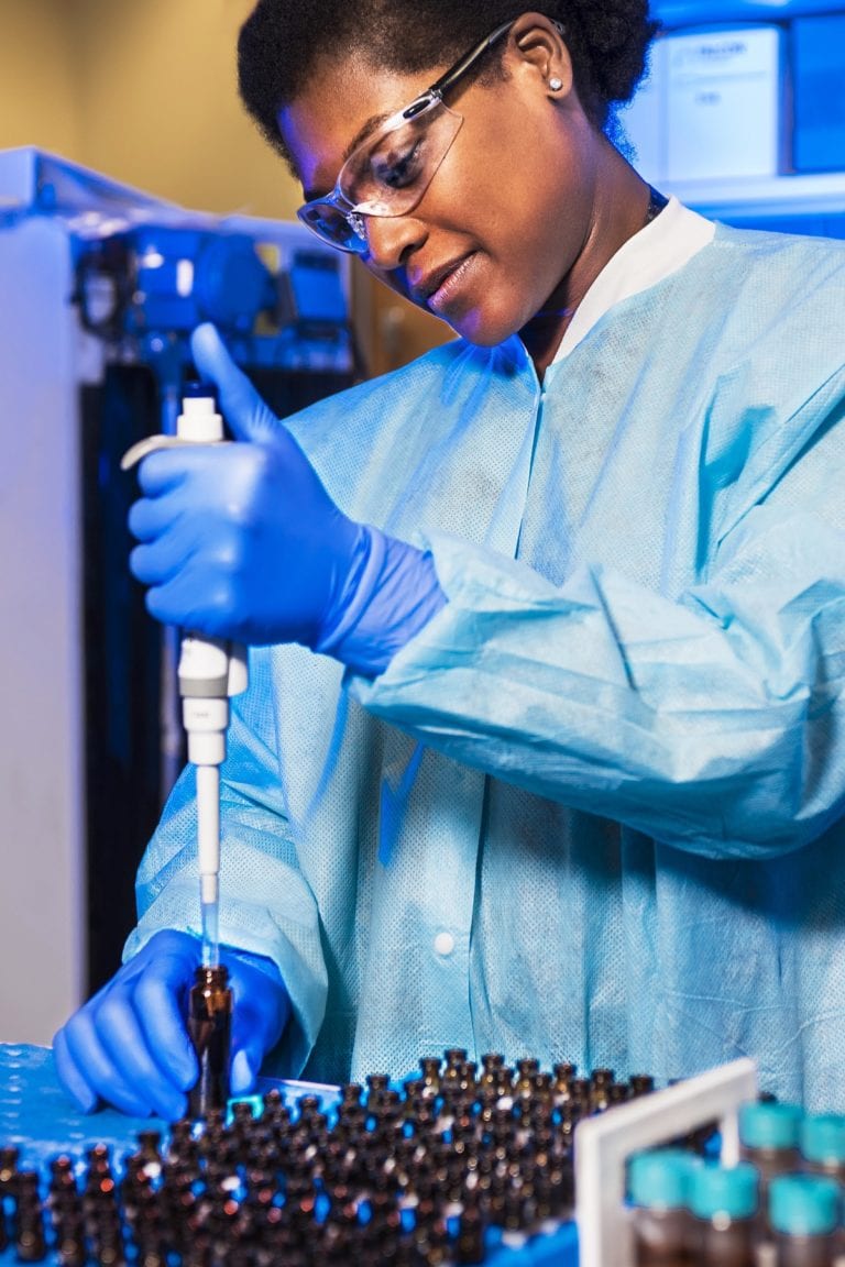 Lab worker filling bottles