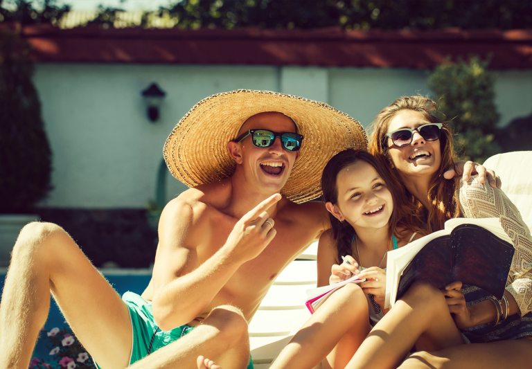 Happy family by a pool