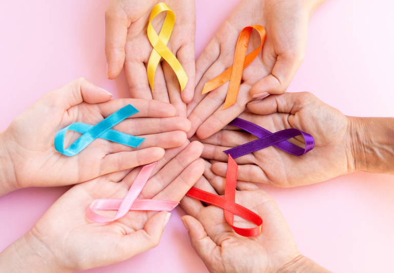 Hands holding color ribbons