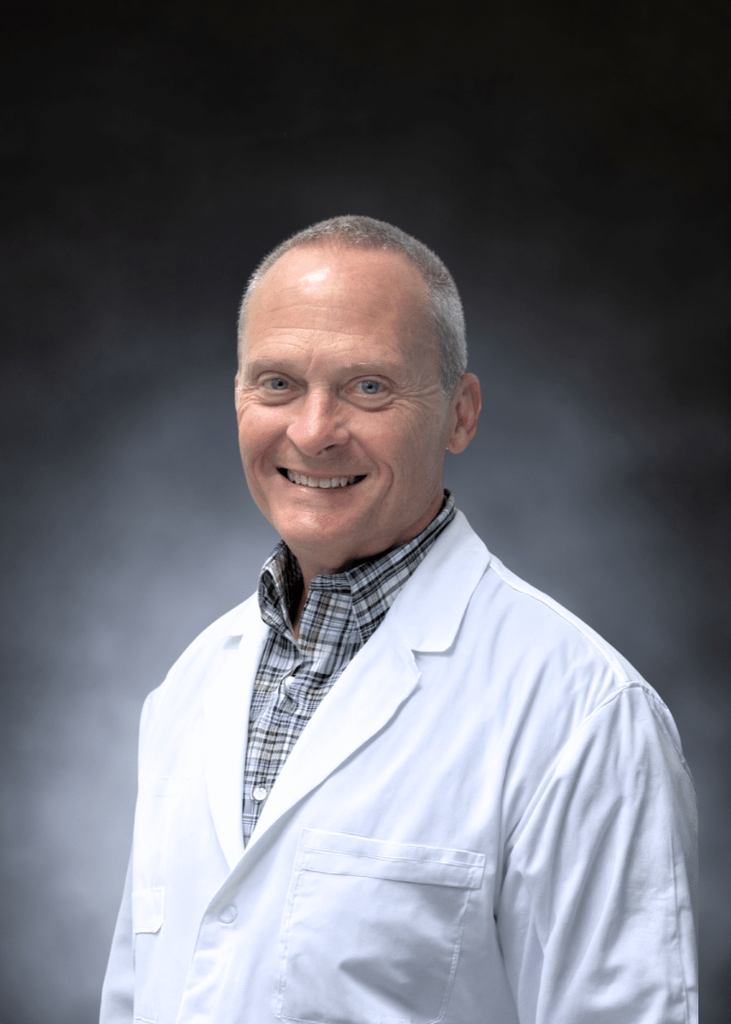Smiling male doctor in white lab coat