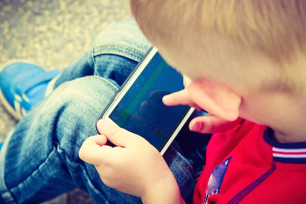 Little kid playing with a tablet