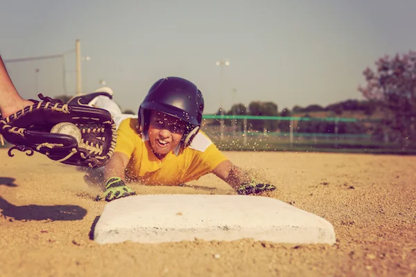 Baseball player sliding into base