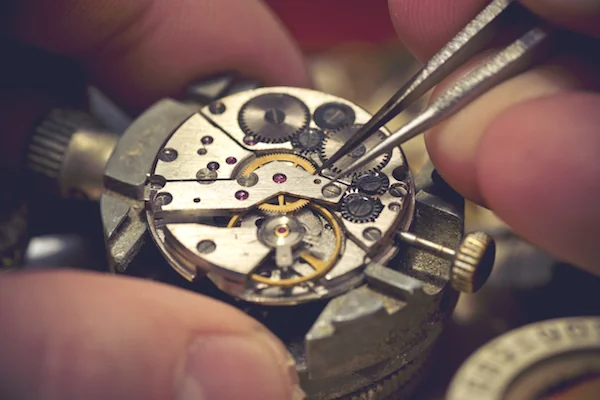 Hands working on a time piece