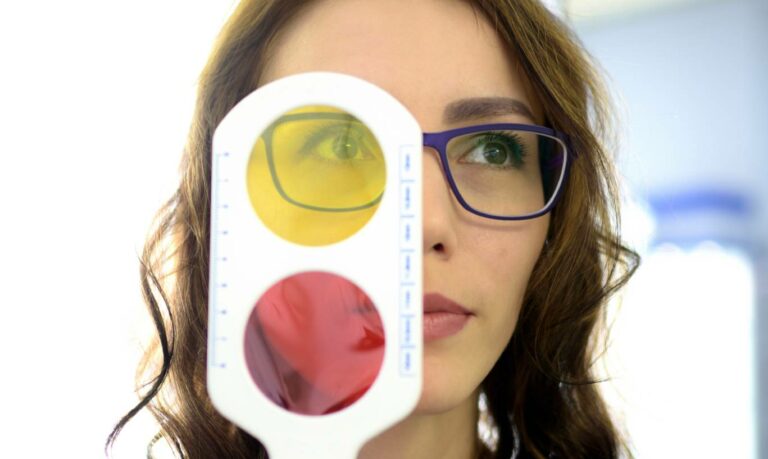 Woman having her eyes examined - Understanding Color Blindness: Symptoms and Solutions